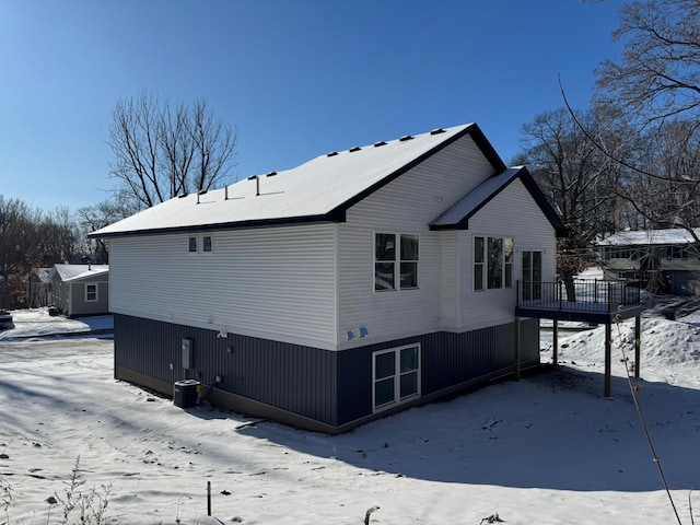 snow covered property featuring a deck