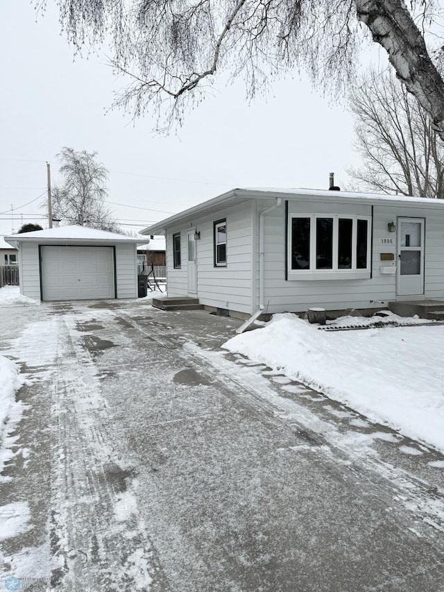 single story home with a garage and an outdoor structure