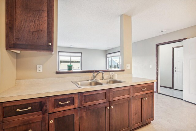 kitchen with a textured ceiling and sink