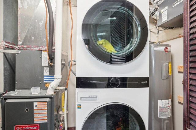 washroom with electric water heater, heating unit, and stacked washer / dryer