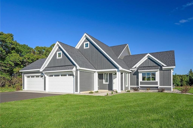 view of front of home featuring a front yard and a garage