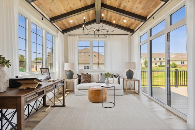 sunroom / solarium featuring a healthy amount of sunlight, a chandelier, lofted ceiling with beams, and wooden ceiling