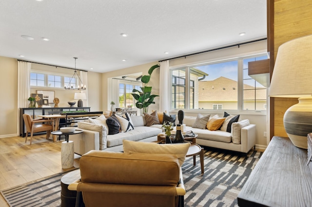 living room featuring hardwood / wood-style floors and a notable chandelier