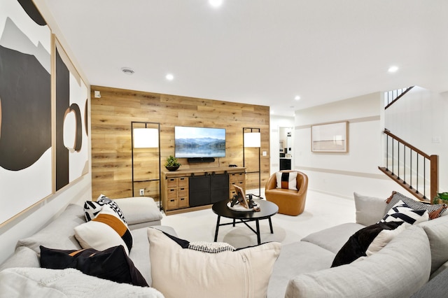 living room with light colored carpet and wooden walls