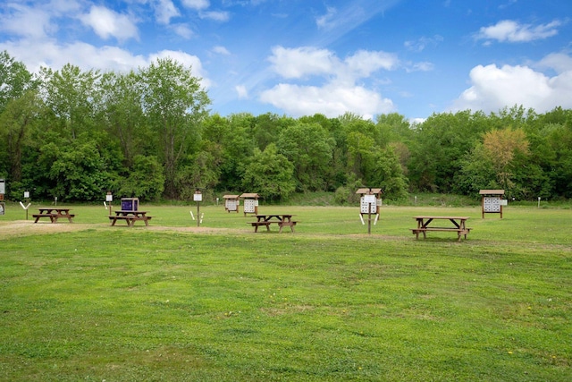 surrounding community featuring a shed and a lawn