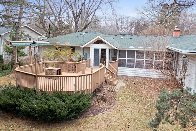 back of house featuring a sunroom and a deck