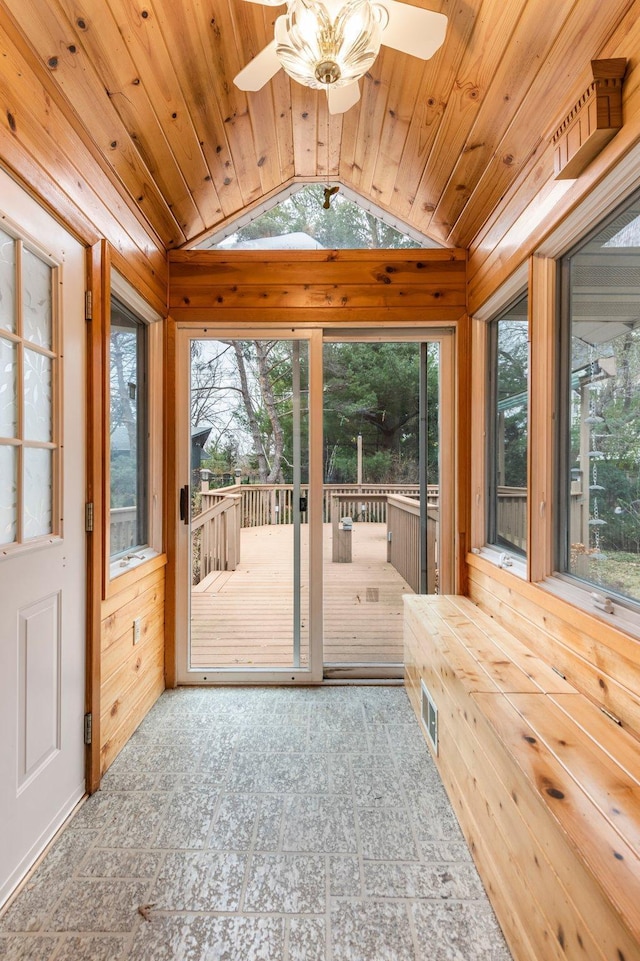 unfurnished sunroom featuring ceiling fan, wooden ceiling, and vaulted ceiling