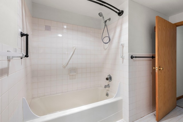 bathroom with tile patterned floors and tiled shower / bath