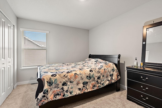 carpeted bedroom with a closet