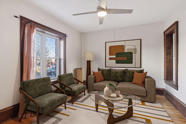 living room featuring ceiling fan and light wood-type flooring