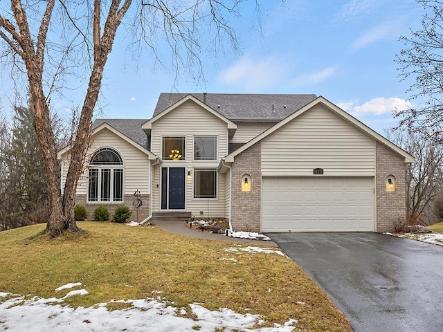 view of front property featuring a lawn and a garage