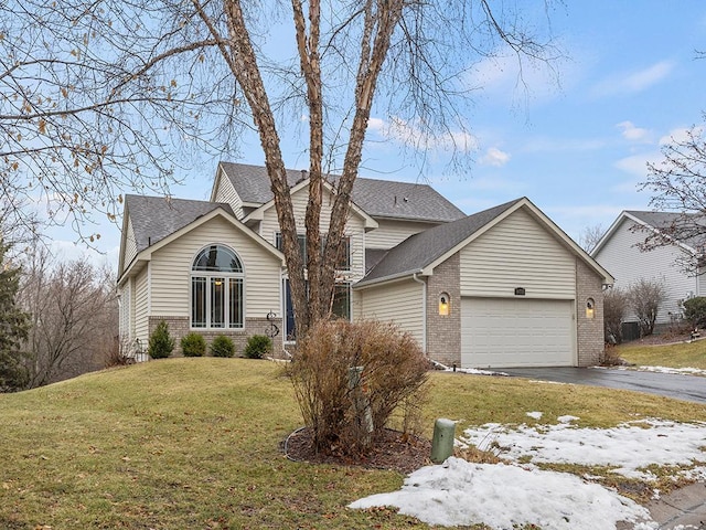 view of front of house with a garage and a front lawn