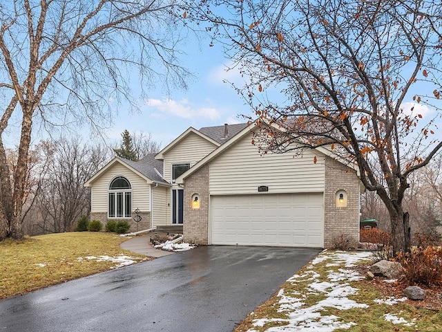 view of front of house featuring a front yard and a garage