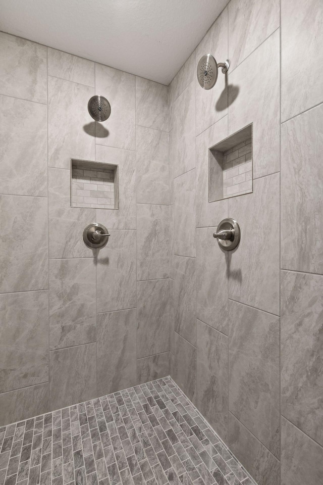 bathroom with tiled shower