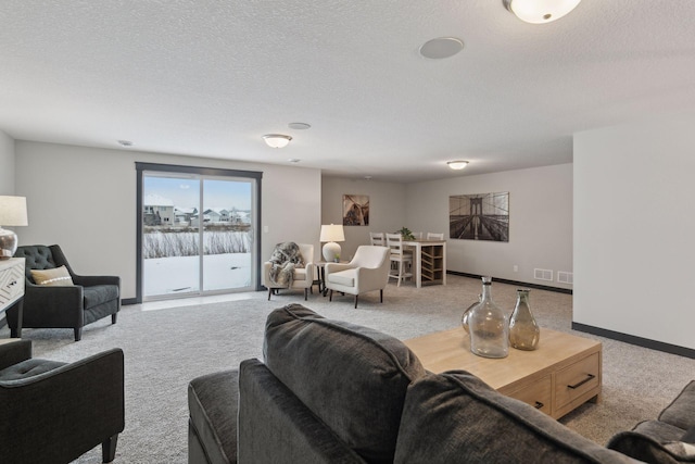 carpeted living room featuring a textured ceiling