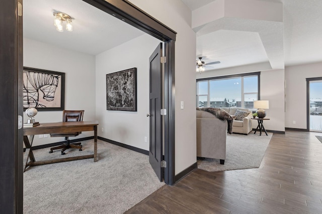 home office featuring ceiling fan and dark wood-type flooring