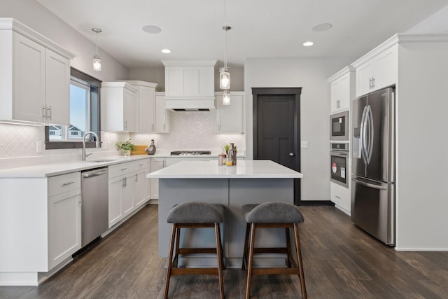 kitchen with pendant lighting, white cabinets, and stainless steel appliances