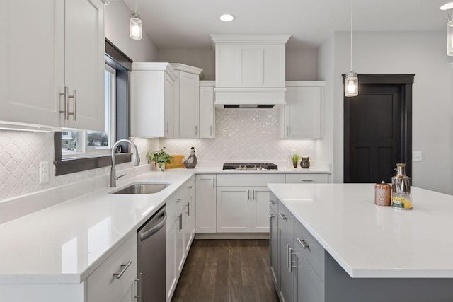 kitchen with sink, hanging light fixtures, dark hardwood / wood-style floors, white cabinetry, and stainless steel appliances