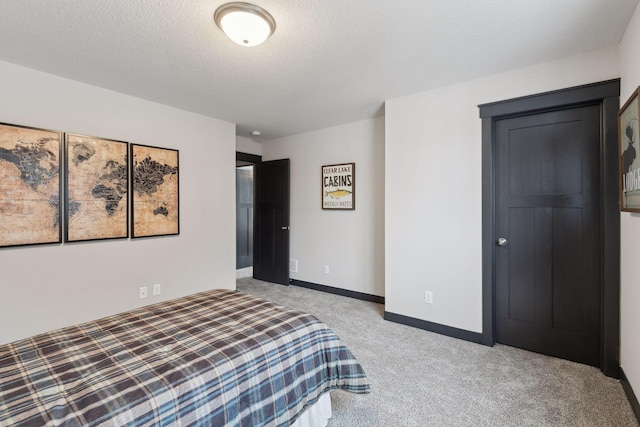 carpeted bedroom featuring a textured ceiling