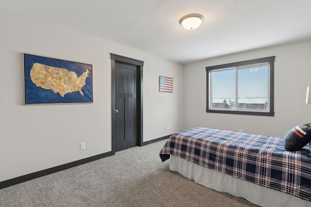 carpeted bedroom featuring a textured ceiling