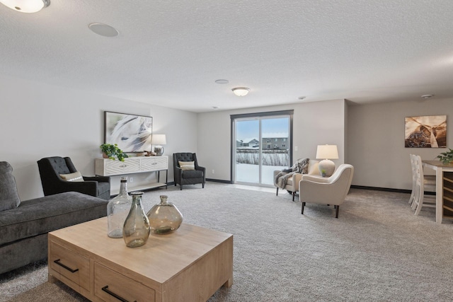 carpeted living room featuring a textured ceiling