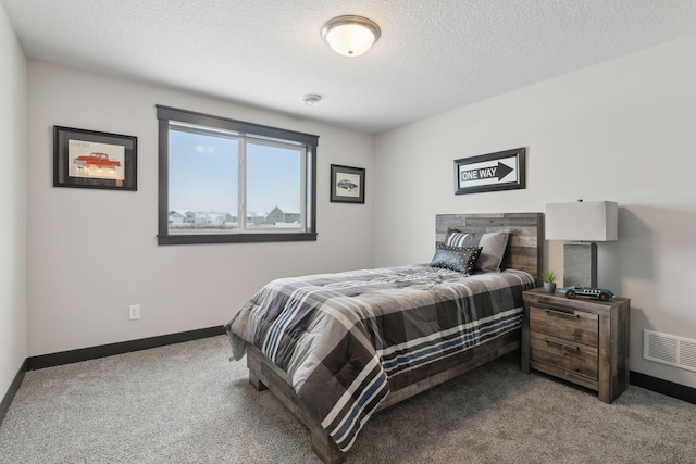 carpeted bedroom with a textured ceiling