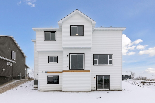 snow covered property featuring central AC