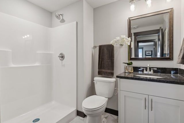 bathroom with vanity, toilet, and walk in shower