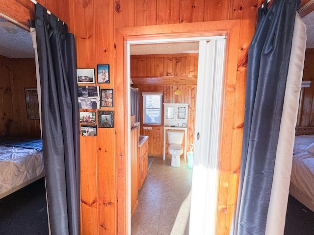 hallway with wood walls