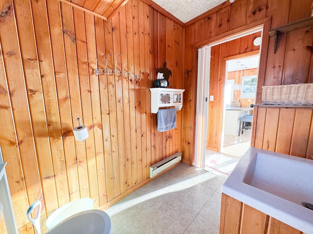 bathroom with wooden walls and a baseboard heating unit