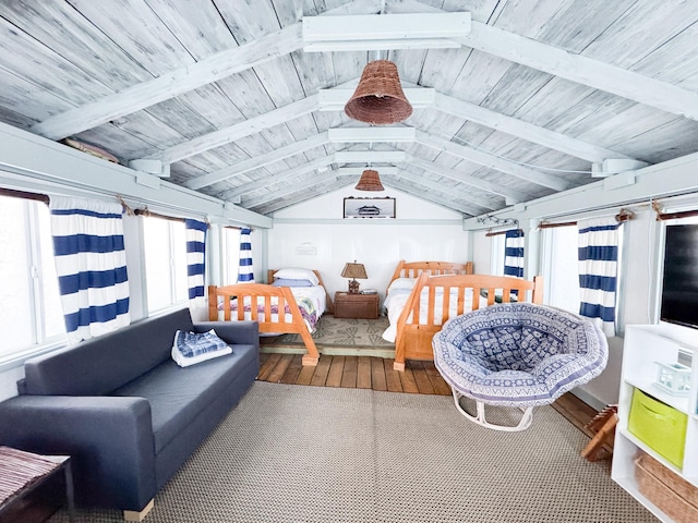 sunroom / solarium featuring lofted ceiling with beams and wood ceiling