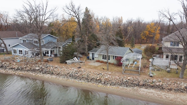 birds eye view of property with a water view and a view of the beach