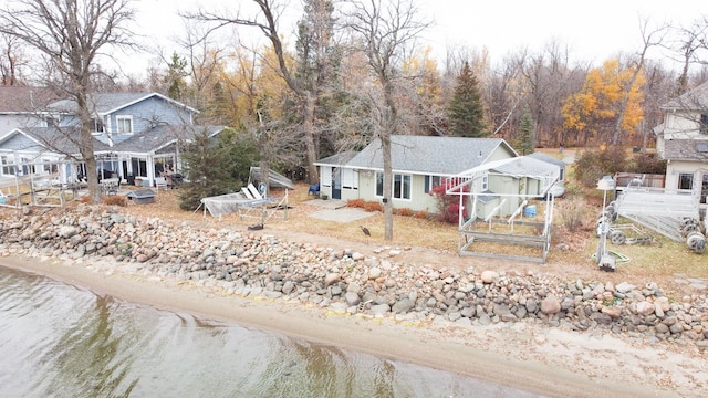 view of front of property featuring a view of the beach and a water view