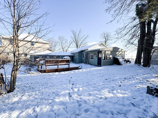 snow covered property featuring a wooden deck