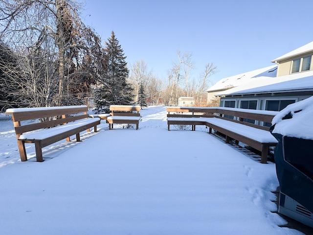 yard covered in snow with a wooden deck