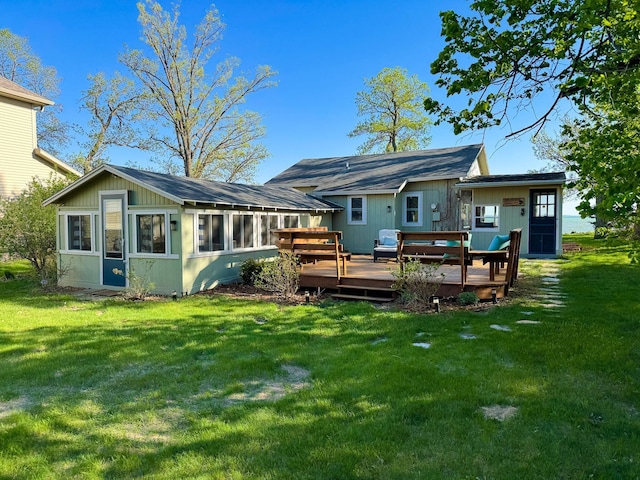 42536 Pleasure Park Rd, Ottertail, MN 56571 - back of property with a sunroom, a wooden deck, and a yard