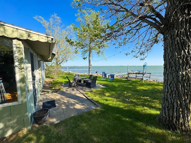 42536 Pleasure Park Rd, Ottertail, MN 56571 - view of grassy yard with a water view and a patio