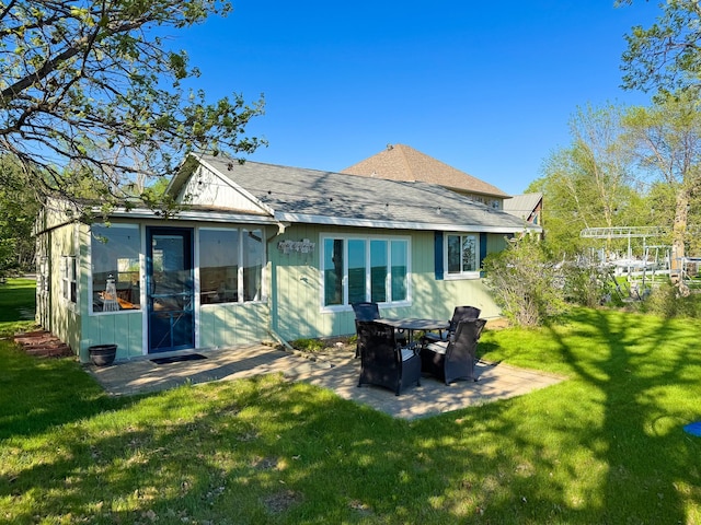 42536 Pleasure Park Rd, Ottertail, MN 56571 - back of property featuring a patio, a lawn, and roof with shingles