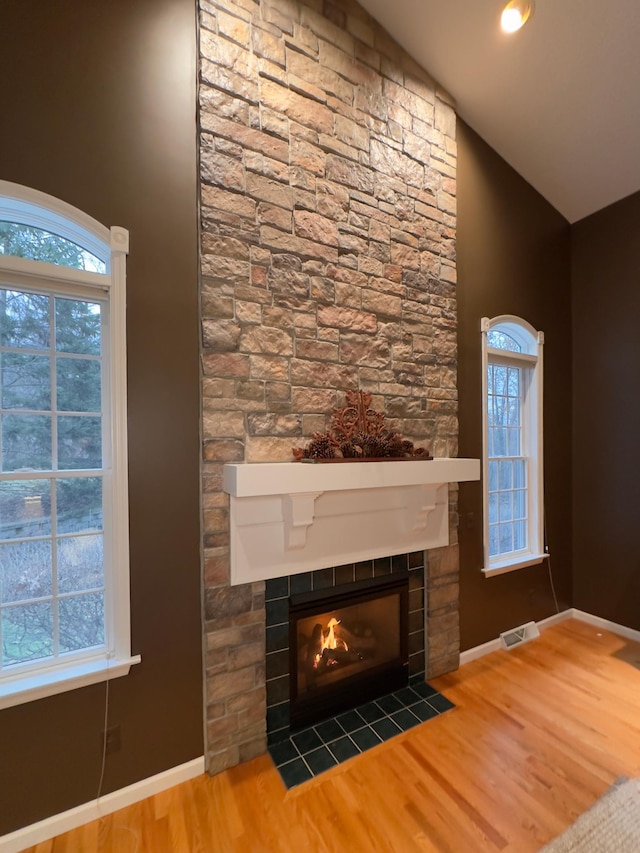 room details with hardwood / wood-style flooring and a fireplace