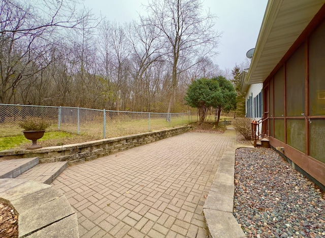 view of patio featuring a sunroom