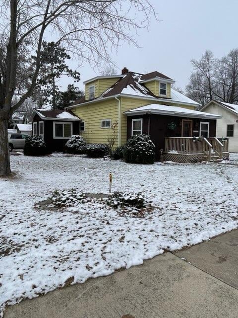 view of snowy exterior featuring covered porch