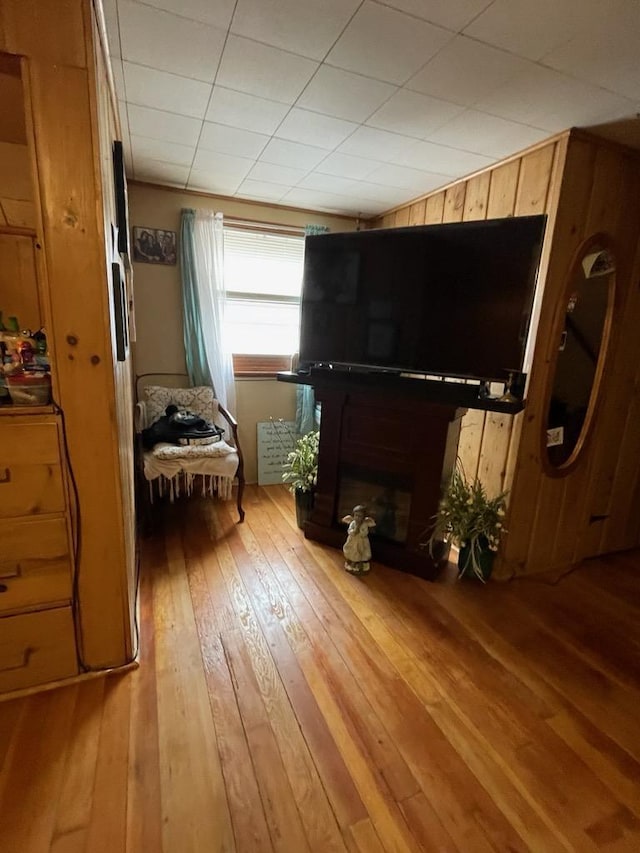 living area featuring hardwood / wood-style floors and wooden walls