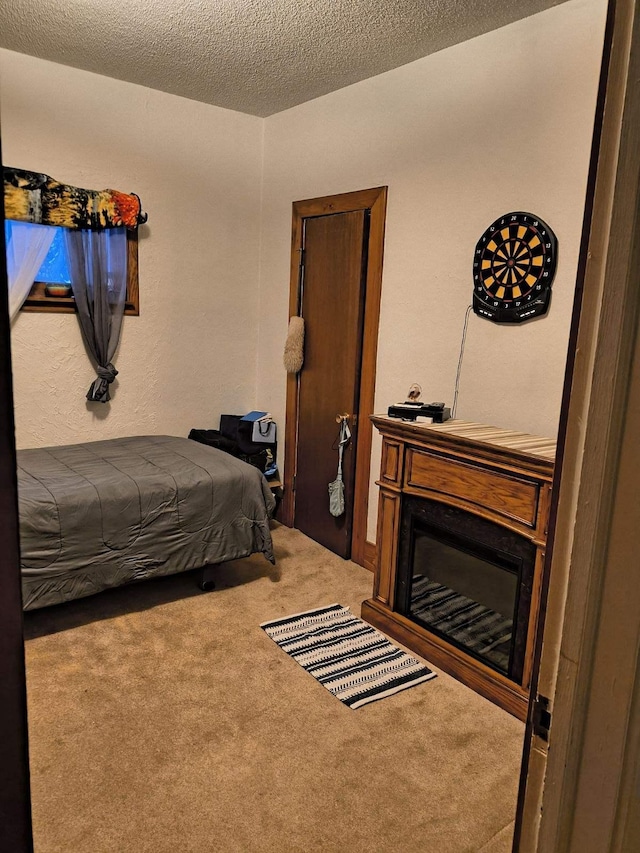 bedroom featuring carpet floors and a textured ceiling