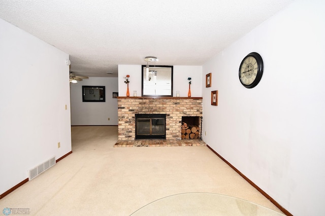 carpeted living room featuring ceiling fan, a textured ceiling, and a brick fireplace