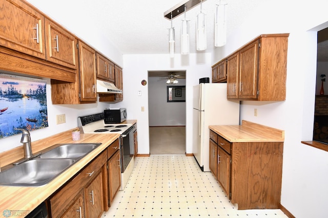 kitchen featuring ceiling fan, sink, hanging light fixtures, white refrigerator, and stainless steel electric stove