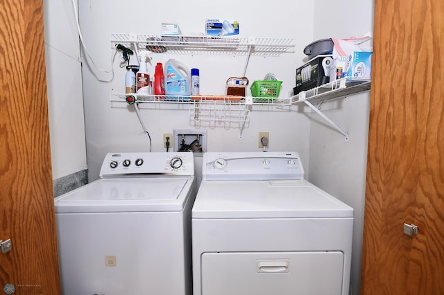 clothes washing area with washer and clothes dryer