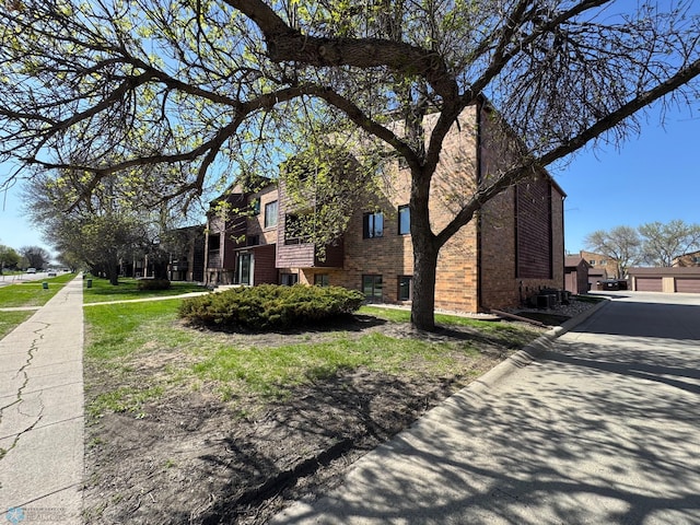 view of side of property featuring brick siding