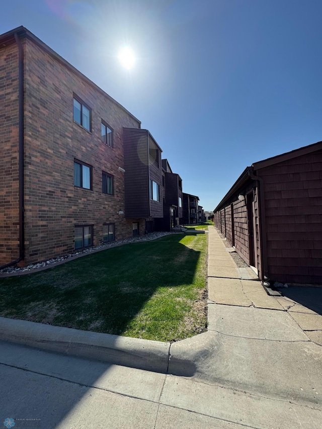 view of property exterior with a lawn