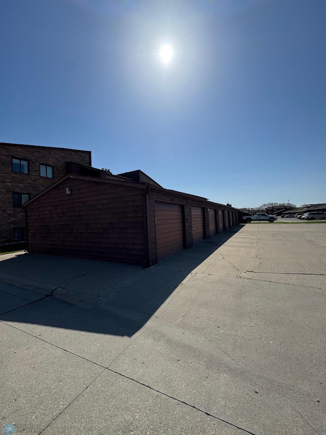 view of side of home featuring community garages