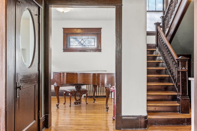 stairs featuring hardwood / wood-style floors